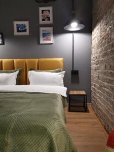 a bedroom with a bed and a brick wall at Nomad Gudauri Twins 124 in Gudauri