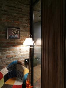 una lámpara en una sala de estar junto a una pared de ladrillo en Nomad Gudauri Twins 124, en Gudauri