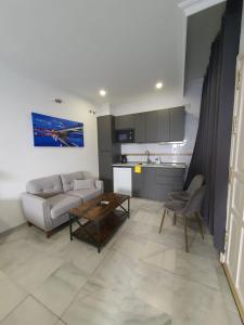 ein Wohnzimmer mit einem Sofa und einem Tisch in der Unterkunft Apartamentos Los Angeles in Sevilla