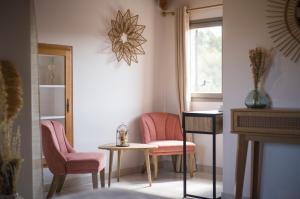 a room with two chairs and a table and a window at Hôtel - Restaurant U Santu Petru in Saint-Florent