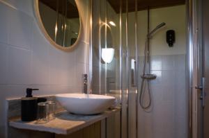 a bathroom with a white sink and a shower at Hôtel - Restaurant U Santu Petru in Saint-Florent