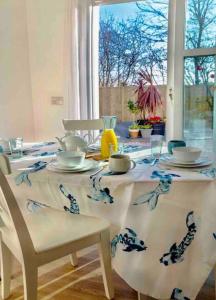 a dining room table with a white and blue table cloth at Lovely 2-Bed House in St Andrews Scotland in St. Andrews