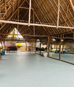 a large room with a large roof with a large concrete floor at The Garden in Paje