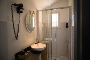 a bathroom with a shower and a sink and a shower at Hôtel - Restaurant U Santu Petru in Saint-Florent