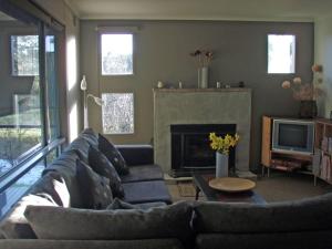 a living room with a couch and a fireplace at Lavandula Country House in Hepburn Springs
