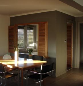 a dining room with a wooden table and chairs at Lavandula Country House in Hepburn Springs