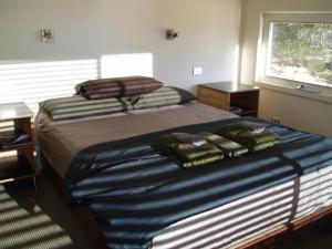 a bedroom with two beds and a window at Lavandula Country House in Hepburn Springs