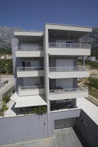 a building with balconies on the side of it at Luxury Apartment Maglica in Makarska