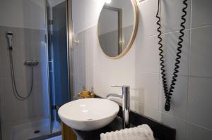 a bathroom with a sink and a mirror at Hôtel - Restaurant U Santu Petru in Saint-Florent