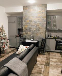 a living room with a couch and a christmas tree at Sinaia Veche in Sinaia