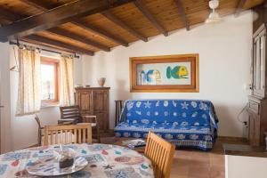 a living room with a table and a bed at Casa Clelia Piazza in Ustica