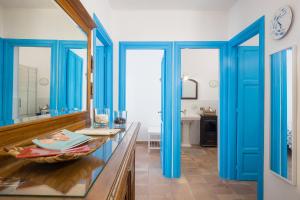 a bathroom with blue doors and a glass counter at Casa Clelia Piazza in Ustica