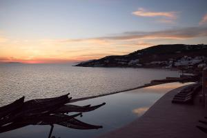 a view of the ocean from a resort swimming pool at Amazon Suites in Agios Ioannis Mykonos