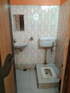 a bathroom with a toilet and a sink at Hotel Hansa Palace by WB Inn in Kānpur