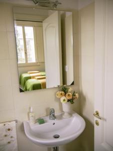 a bathroom with a white sink and a mirror at Zula Affittacamere in Florence +10 photos