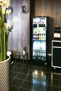 a drink refrigerator in a restaurant with a table at Plaza Hotel & Living Frankfurt in Frankfurt/Main