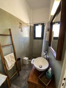 a small bathroom with a sink and a toilet at La Pausa in Porto Heli