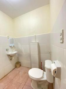 a bathroom with a toilet and a sink at A's Guest House in Buaya +14 photos