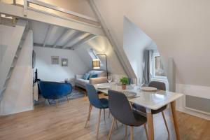 een eetkamer en een woonkamer met een tafel en stoelen bij Charmant appartement en plein centre du Pouliguen! in Le Pouliguen