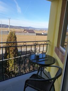 a balcony with a table and a view of a field at One Room Studio in Râşnov