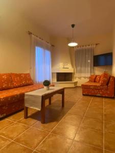 a living room with a couch and a coffee table at Luna Bay in Agios Ioannis Pelio