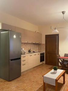 a kitchen with a stainless steel refrigerator and a table at Luna Bay in Agios Ioannis Pelio