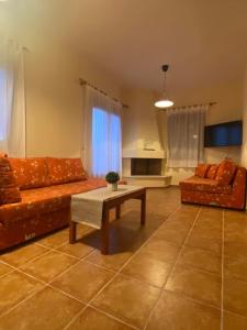 a living room with two couches and a coffee table at Luna Bay in Agios Ioannis Pelio