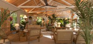 salon ze stołami, krzesłami i roślinami w obiekcie Veranda Grand Baie Hotel & Spa w mieście Grand Baie