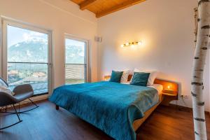 a bedroom with a bed and a large window at Villa Bergl.21 in Brixlegg