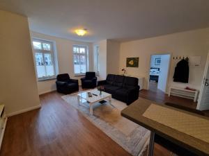 a living room with a couch and a table at Villa Schönfeld Wohnung 1 in Papenburg