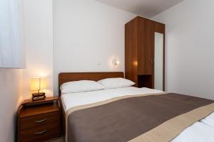 Posteľ alebo postele v izbe v ubytovaní Apartments Crneković V