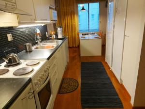 a kitchen with a sink and a counter top at City Apartment Tulliportti in Kuopio