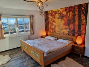 1 dormitorio con 1 cama y una gran pintura en la pared en Landhaus Weindl, en Schönau am Königssee