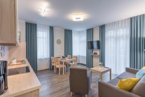 ein Wohnzimmer mit einem Sofa und einem Esszimmer in der Unterkunft BSW Ferienwohnungen Rügen in Baabe
