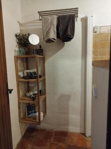a hallway with a shelf with clothes hanging on a wall at Mas Del Llop Blanc - Dog friendly Hostal Rural - B&B in Sobrestany
