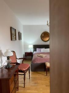 a bedroom with a bed and a desk and a chair at Willa Art Deco in Ustroń