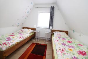 a bedroom with two beds and a window at Haus Silvia 