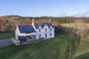 an aerial view of a large white house at Greenmyre Farmhouse with Hot Tub in Kirriemuir