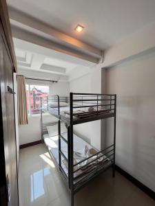 a room with two bunk beds and a window at BB House Budget & Boutique in Chiang Mai