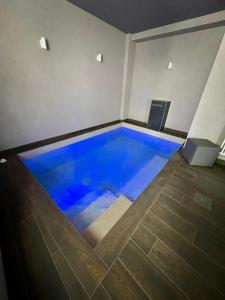 a large blue swimming pool in a room at Hotel Bella Napoli ristorante & spa in Foggia