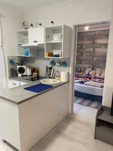 a kitchen with a sink and a bed in a room at City Center Apartman 2. Nagykanizsa in Nagykanizsa