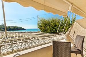 a balcony with chairs and a view of the ocean at Kalogria in Stoupa
