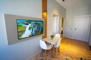 a room with a table and chairs and a painting on the wall at Moon Suites in Antalya