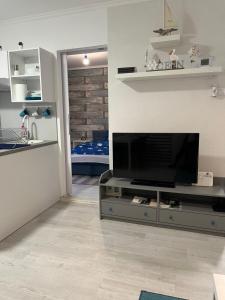 a living room with a flat screen tv on a entertainment center at City Center Apartman 2. Nagykanizsa in Nagykanizsa