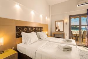 um quarto de hotel com duas camas e uma janela em Kalogria em Stoupa