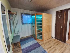 a room with a shower and a chair in it at Apfelhaus beim Hennesee in Meschede