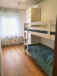 a bedroom with two bunk beds and a window at Apfelhaus beim Hennesee in Meschede