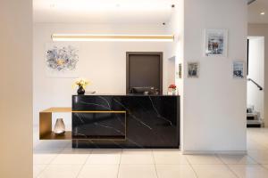 a lobby with a black counter and a desk at Hôtel Nice Azur Riviera in Nice