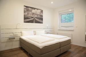 a bedroom with a large bed with a picture on the wall at Main Motel in Dorfprozelten