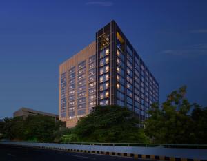 a tall building with lights on in front of it at Hyatt Regency Ahmedabad in Ahmedabad